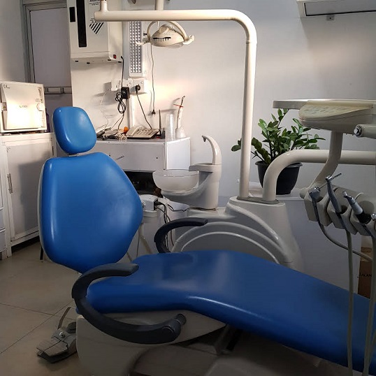 Blue dental chair and clinical equipment in a treatment room